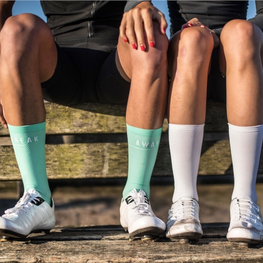 Image banner showing 2 cyclist with clean socks for the blog post "how to keep white socks white"